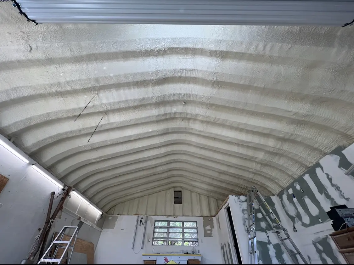 Spray polyurethane foam applied to the underside of a metal roof deck in Marshall